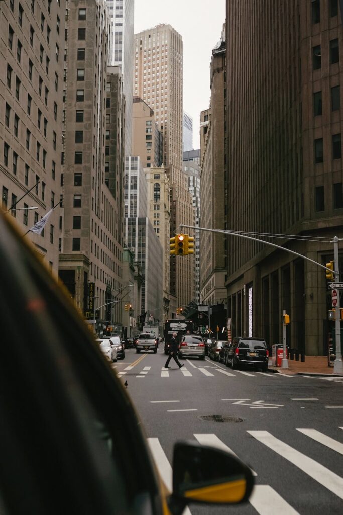 car waiting green traffic light on crossroad of modern city